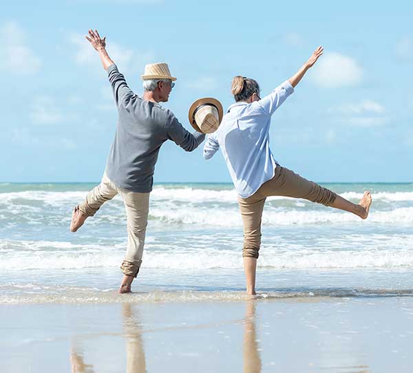 Asain retired couple having fun on beach