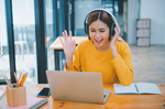 Educator online with headphones and laptop