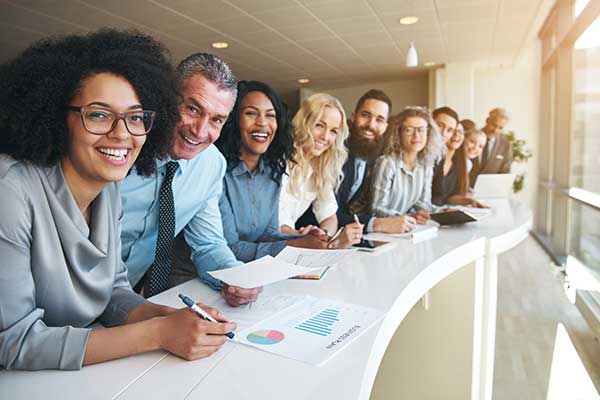 Diverse group along table in office