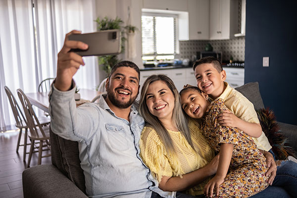 Family on couch taking selfie