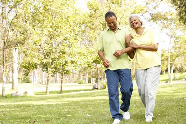 Older African American couple walking outside