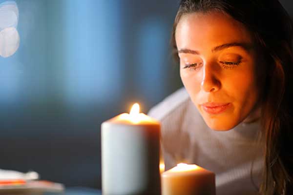 Woman blowing out candle