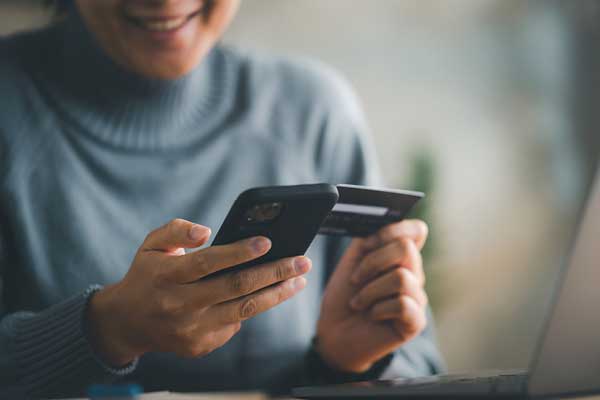 Educator looking at mobile device to purchase something