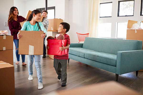 Hispanic family with boxes moving into new home