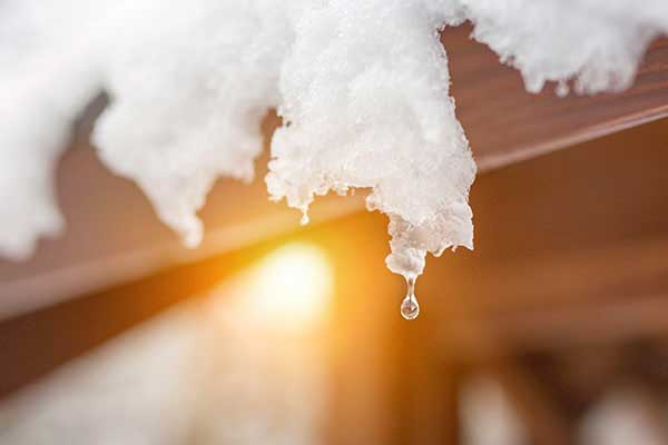 Close up of snow melting off roof