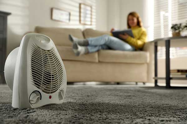 Space heater with woman relaxing on couch