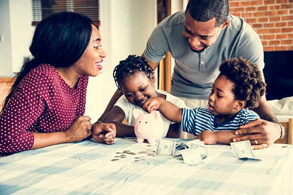 African American family with young children teaching about money