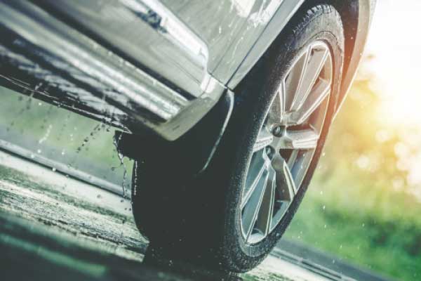 Lower half of automobile on wet road