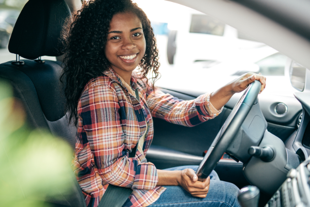 Smiling teen driver in car