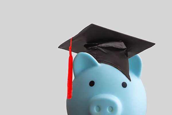 Blue piggy bank with graduation cap