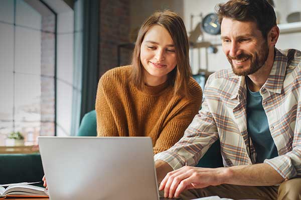 Couple doing their taxes in front of laptop