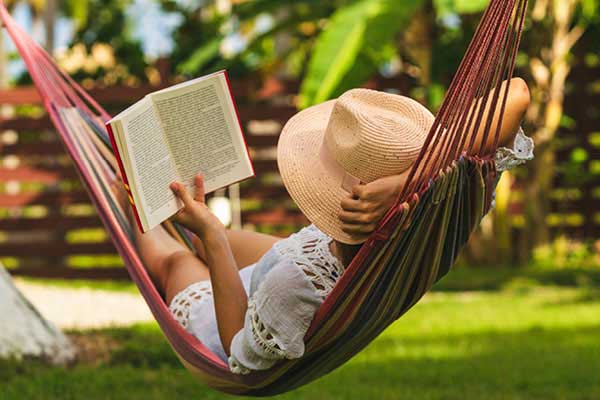 Woman reading in a hammock outside