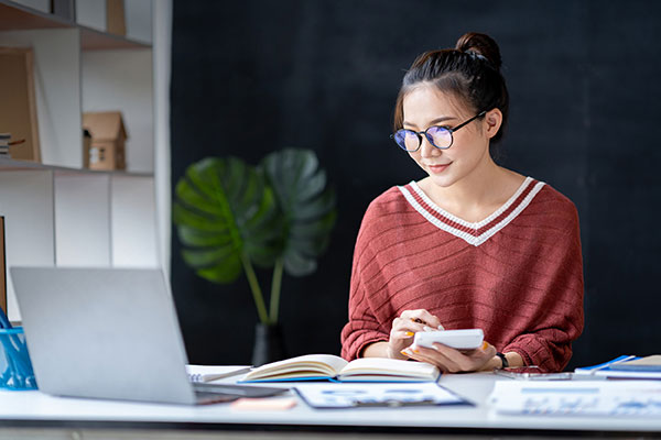 young educator at desk in classroom