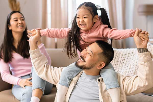 Asian American family playing in their home