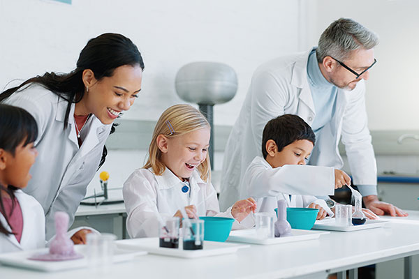 Science teacher and students in science lab