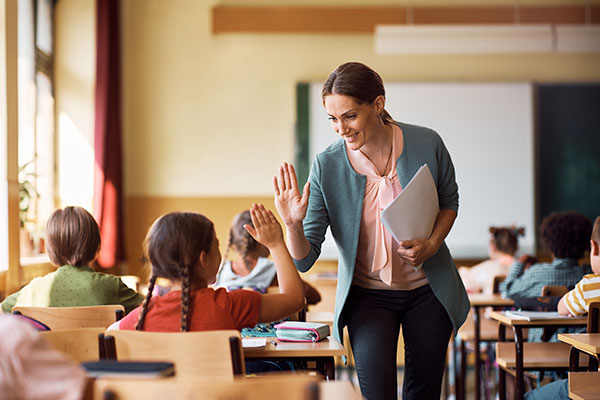 Teacher giving student a high five