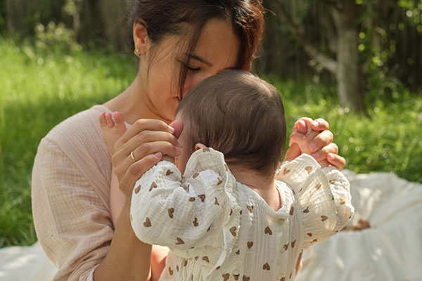 Mother with baby outside on a blanket