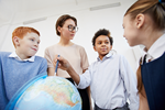 Educator with globe and students