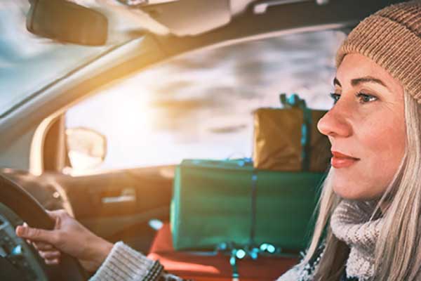 Woman driving with gifts in passenger side