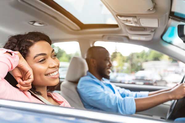 Young African American couple driving