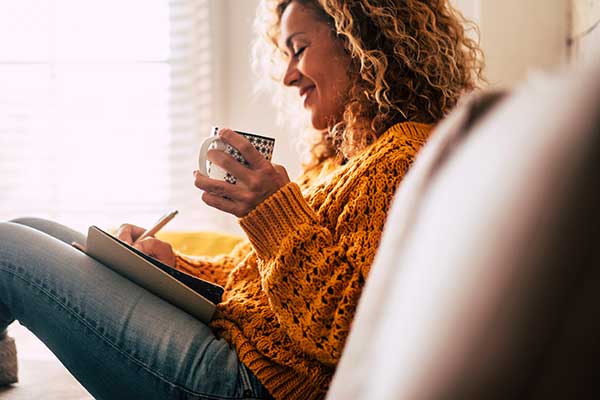 Woman in sweater relaxing with a cup of coffee