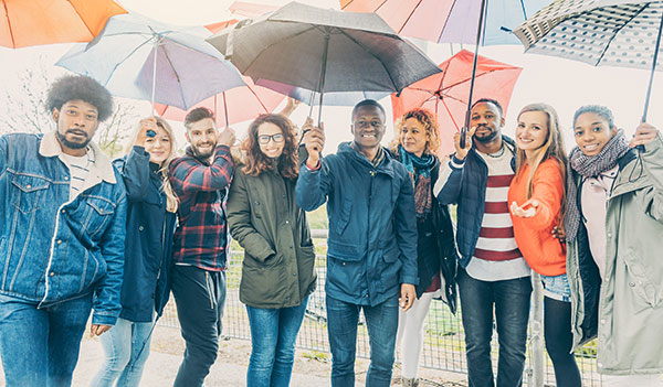 Diverse teachers under umbrellas