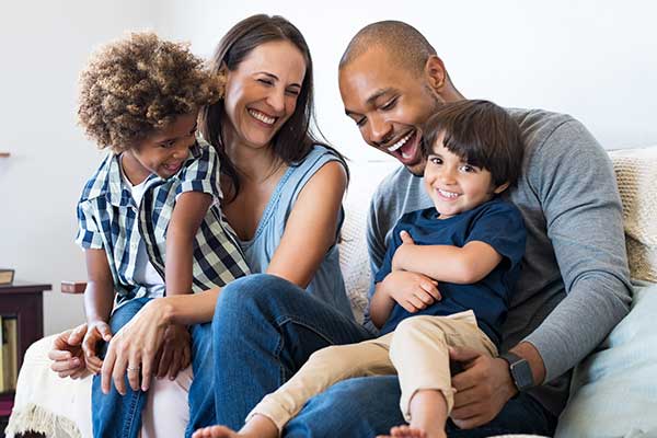 Mixed family with young children on couch